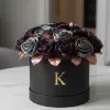 An overhead aerial shot of 24 handcrafted satin ribbon roses arranged in a dense, symmetrical pattern. The contrast between the deep plum and charcoal satin textures with rose gold accents is visible, showcasing the meticulous craftsmanship of the Konceptify Noir collection.